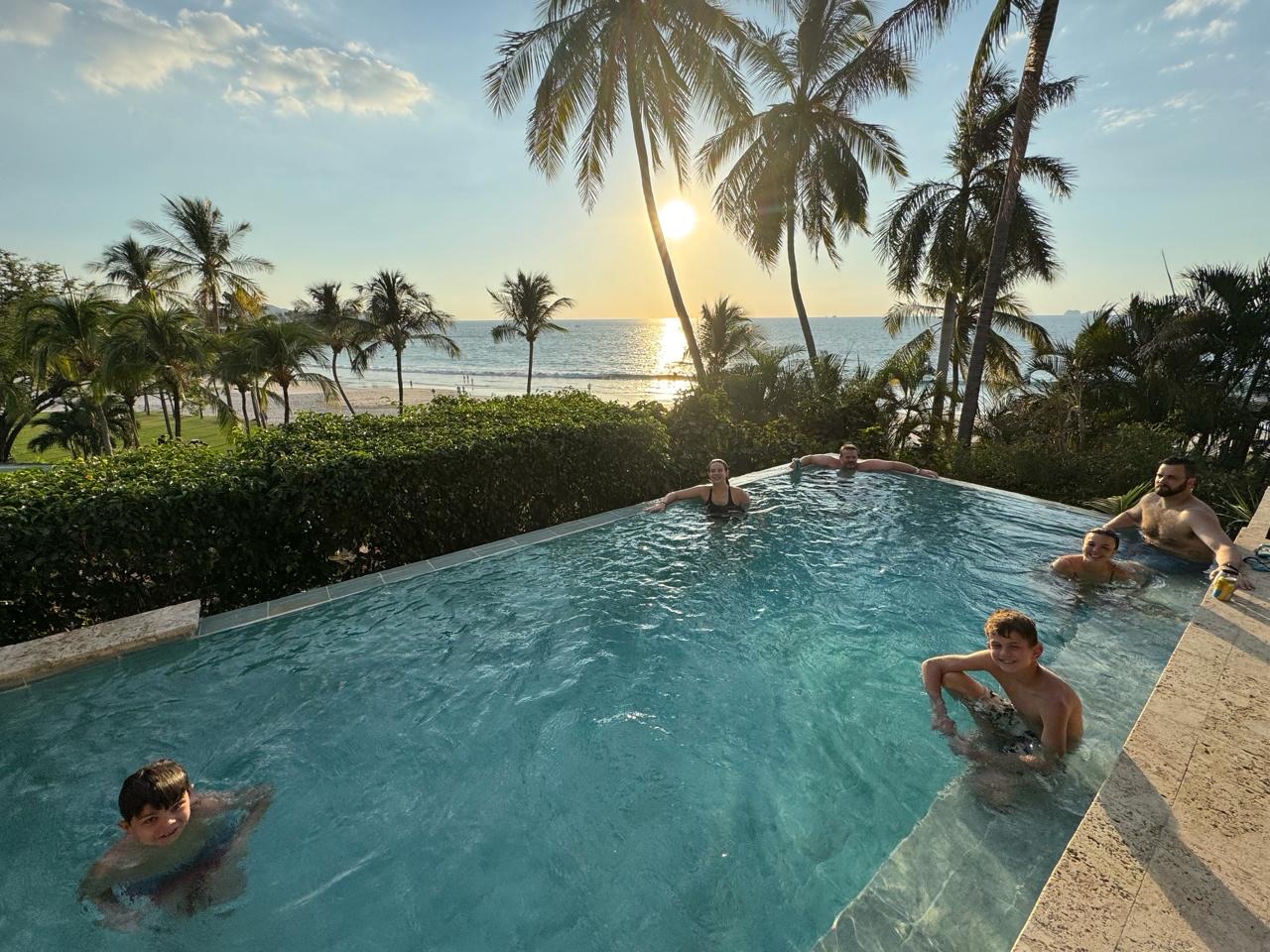 The crew in the pool overlooking the beach