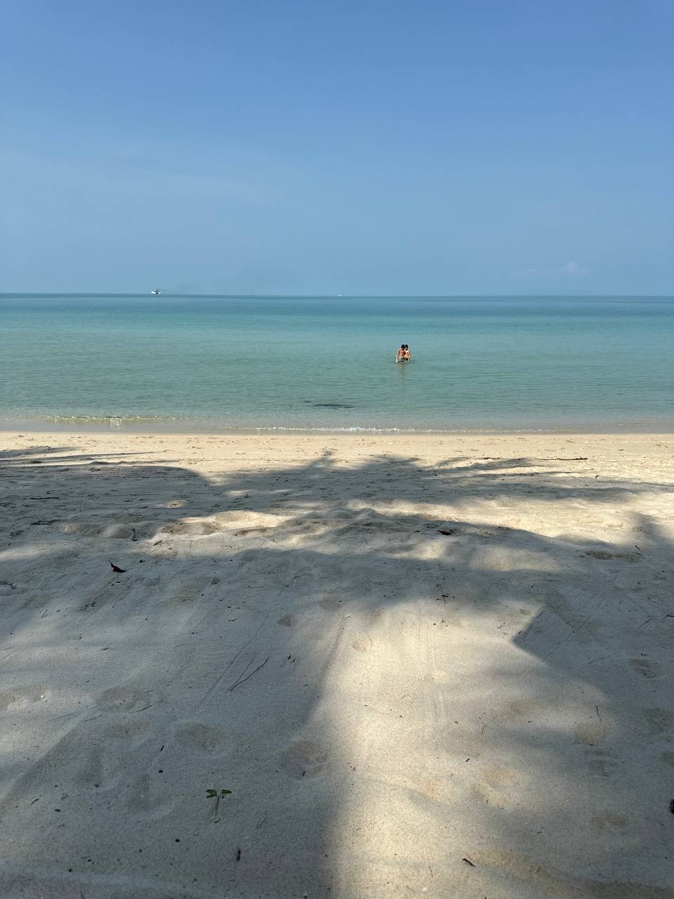 Calm turquoise water and white sand beach