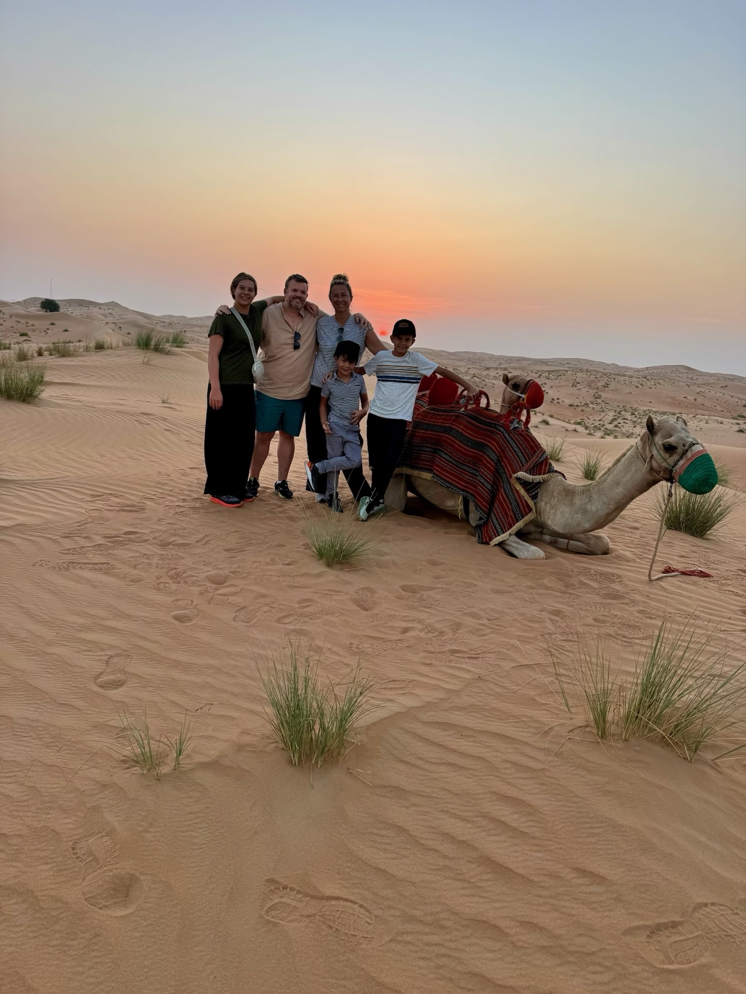 With a camel at sunset